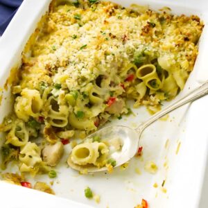 Partially served pasta casserole in white dish with tuna.