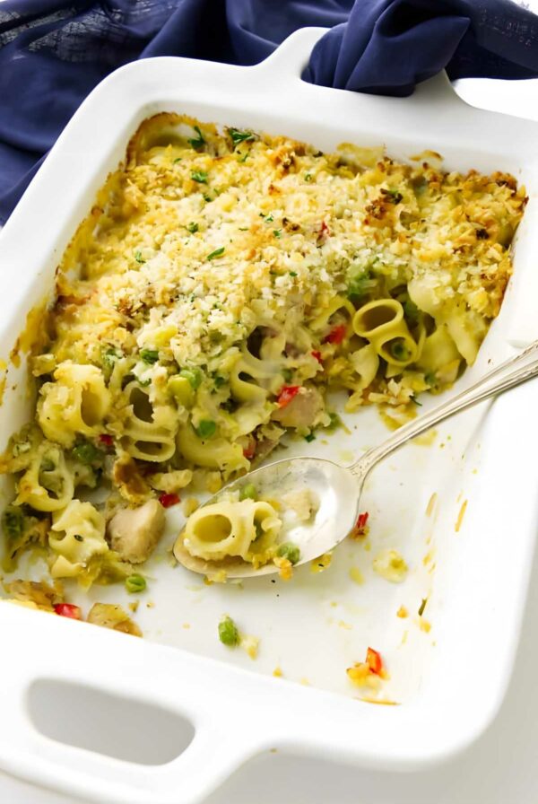 Partially served pasta casserole in white dish with tuna.