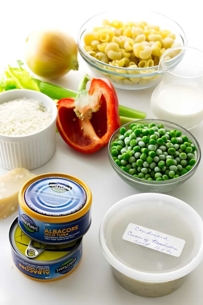 Ingredients for tuna casserole arranged on a white surface.