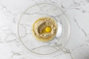 Mixing bread crumbs with eggs.