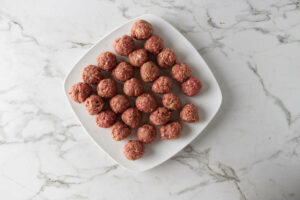 Rolling meat into balls and setting aside.