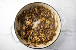 Browning mushrooms in a skillet.