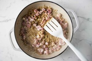 Cooking pancetta with the sauteed onions.