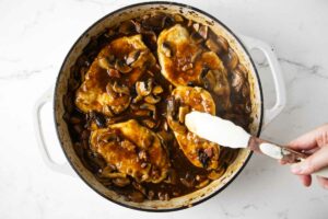 Returning the chicken to the mushroom marsala sauce.