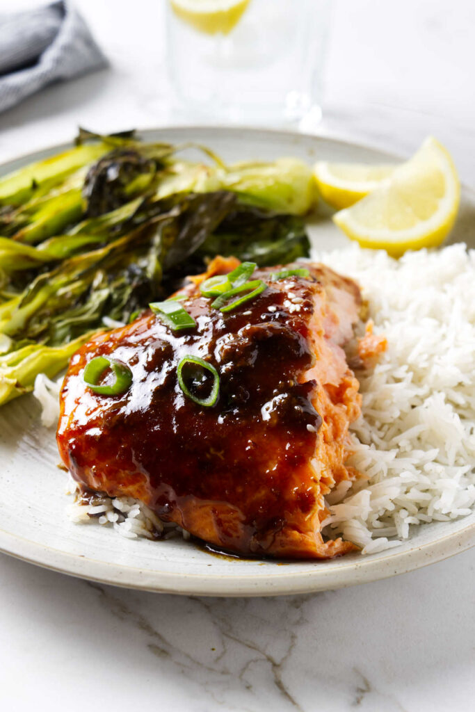 A dinner plate with a serving of salmon glazed in ginger soy.