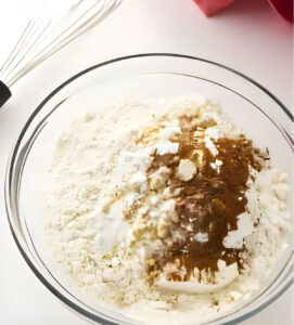 Whisking the dry ingredients in a mixing bowl.
