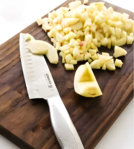 Chopping fresh apples on a cutting board.