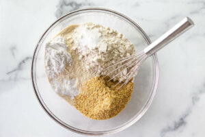 Whisking dry ingredients in a bowl.