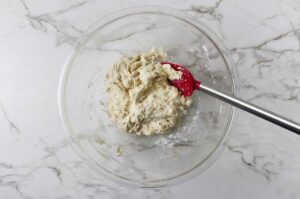 Mixing the wet ingredients into a shaggy dough.