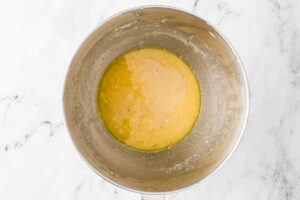 Combining the ingredients for a sourdough sugar cookie dough.
