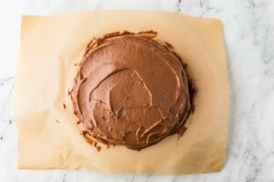 Spreading frosting on a round layer cake.