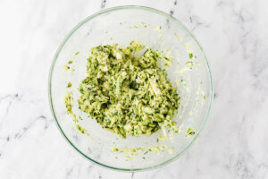 Shredded zucchini in a mixing bowl.