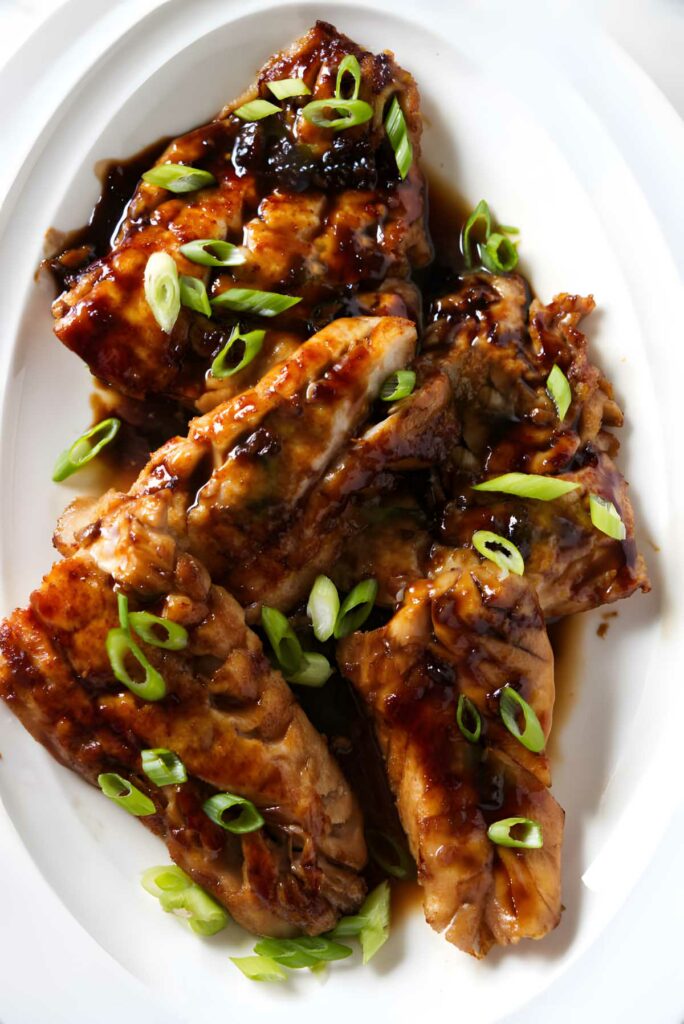 A platter with several soy glazed Asian rockfish fillets.
