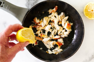 Warming dungeness crab in a skillet.