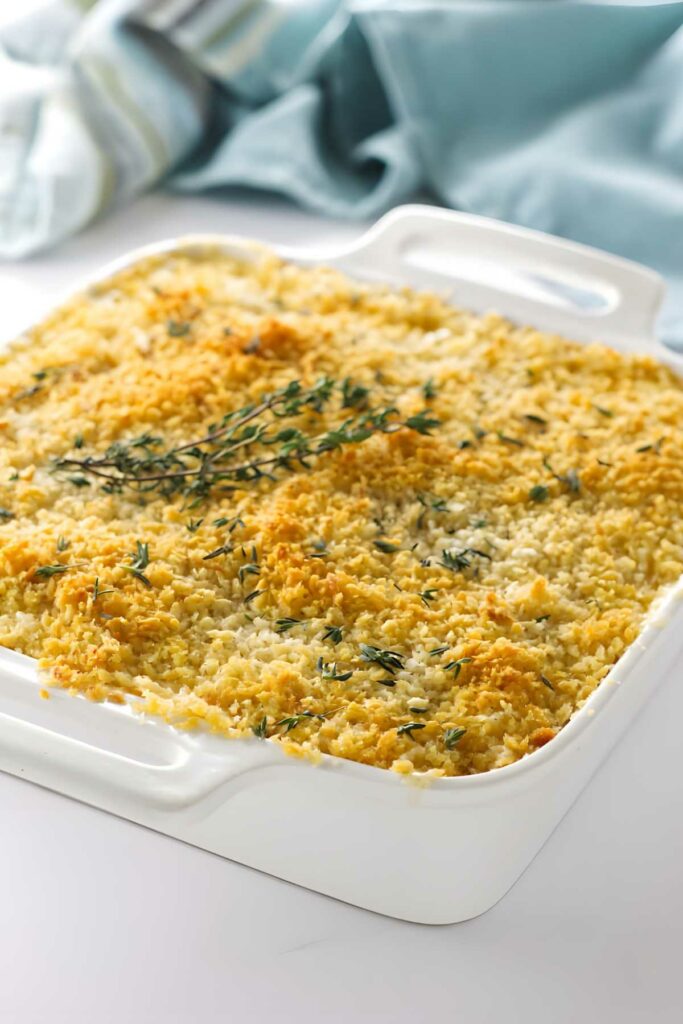 Golden breadcrumb-topped mac casserole in white dish.