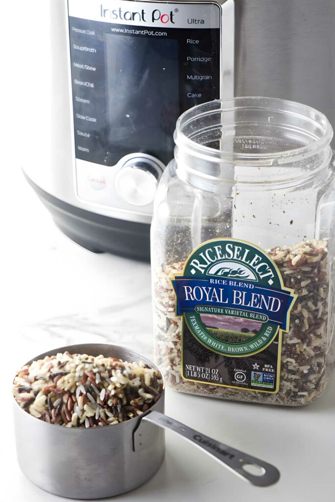 RiceSelect Royal Blend rice and Instant Pot with measuring cup of mixed grains.