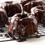 Drizzling chocolate mint glaze on a mini bundt cake.