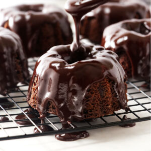 Drizzling chocolate mint glaze on a mini bundt cake.