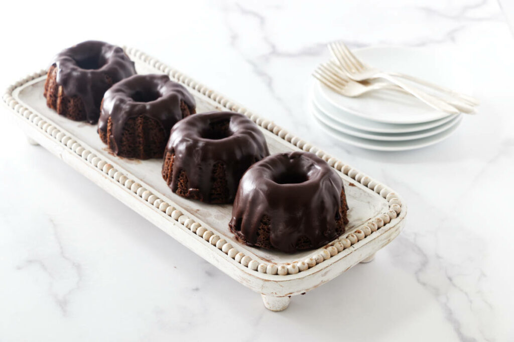 Four chocolate mint bundt cakes on a tray.