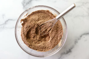 Sifting dry ingredients in a bowl.