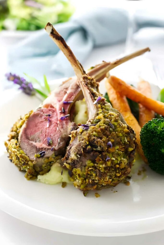 Pistachio crusted lamb chops on mashed potatoes with roasted vegetables.