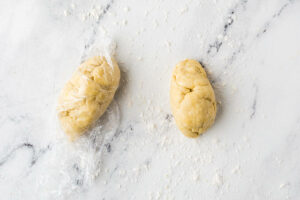 Dividing pasta dough into sections.