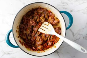 Browning ground chicken in a large stock pot.