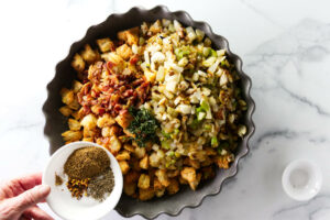 Adding the vegetables and spices too the bowl for fennel stuffing.
