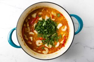 Stirring cilantro into brazilian fish soup.