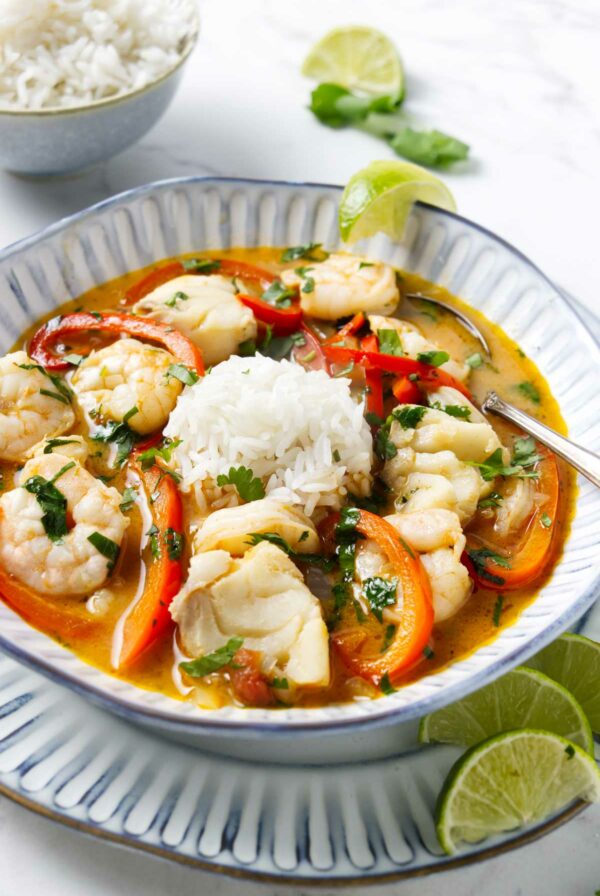 Rice and moqueca Brazilian fish stew in a soup bowl.