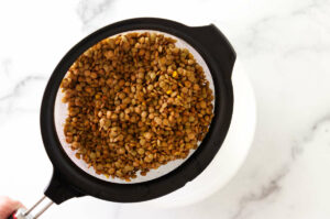 Rinsing the lentils before adding them to the soup.