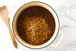 Adding the lentils to the soup.
