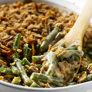A spoon scooping a fresh green bean casserole recipe.