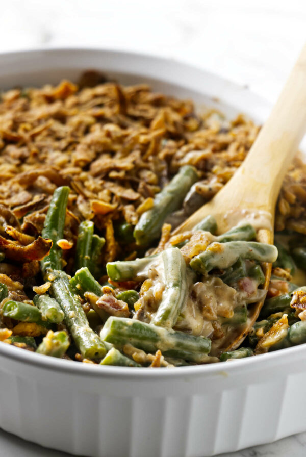 A spoon scooping a fresh green bean casserole recipe.