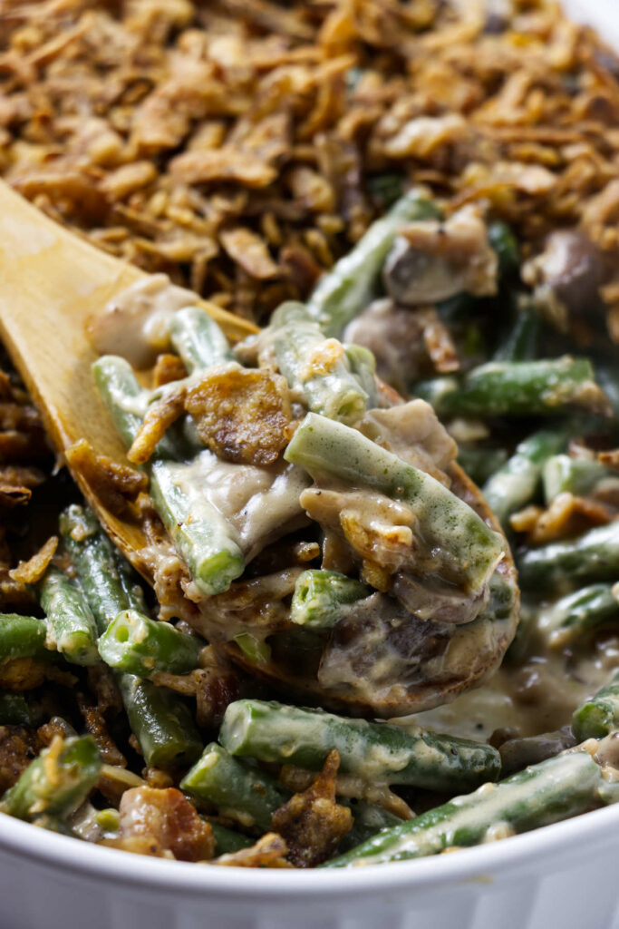 A homemade green bean casserole in a white dish.
