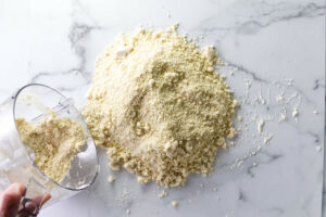Dumping pie dough out onto a counter to form it into a crust.