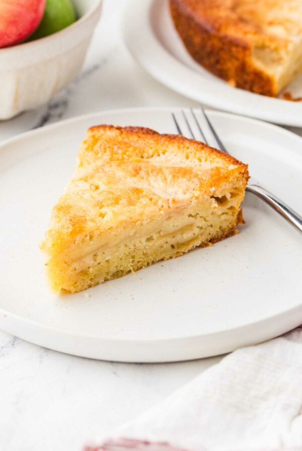 A slice of apple sourdough discard cake on a dessert plate.