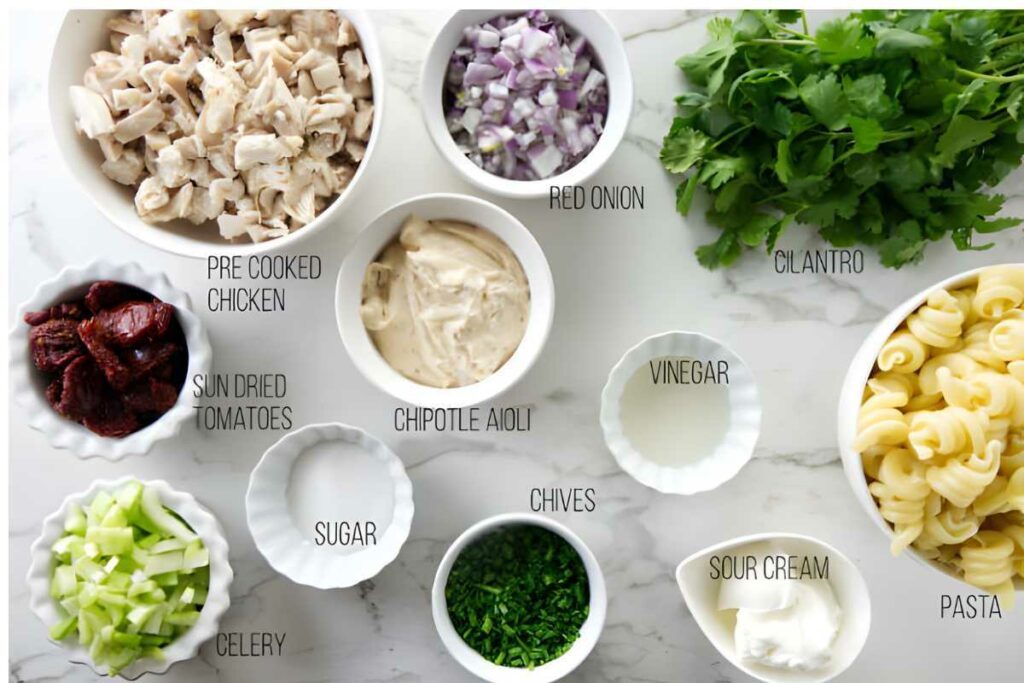 All the ingredients used for a spicy chicken pasta salad.