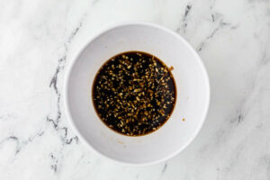 Mixing teriyaki sauce in a small bowl.
