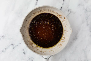 Simmering homemade teriyaki sauce in a pan.