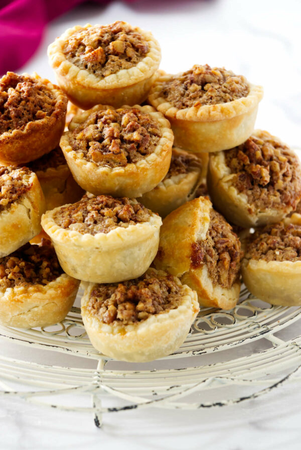 Several pecan pie tassies on a white counter.