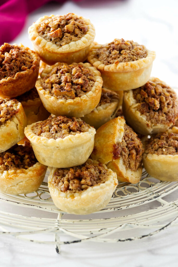 Several pecan pie tassies on a white counter.