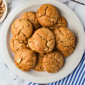 A dessert plate filled with thick peanut butter cookies made with sourdough.