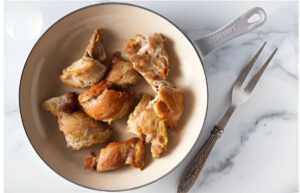 Browning chicken in a skillet on the stove top.