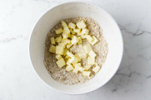 Cubes of butter in a bowl with oatmeal crunch topping.