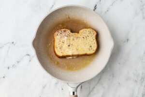Cooking homemade french toast in a skillet.