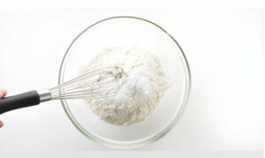 Whisking the dry ingredients together in a bowl.