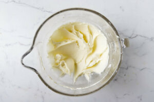 Mixing the cream cheese filling in a mixing bowl.