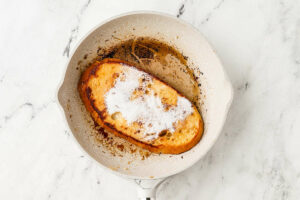 Cooking sourdough french toast in a skillet.