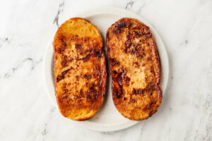 Two slices of french toast on a plate.